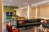 Contemporary lounge area with a cozy sofa, stylish decor, pool table, and flat-screen TV, perfect for relaxation and entertainment.