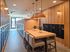 Modern apartment lobby featuring sleek mailbox units, elegant wooden paneling, and a stylish communal table with plush seating.