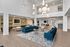 Luxurious and spacious living area with modern furniture, elegant pendant lighting, and a cozy fireplace, perfect for relaxation and entertaining.