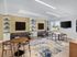 Modern living area with cozy seating, elegant wood floors, built-in shelves, and an inviting fireplace.
