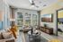Bright and airy living room with large windows, modern furnishings, and stylish decor, perfect for relaxation and entertainment.
