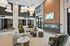 Luxurious and modern apartment lounge with elegant decor, featuring a sleek sectional sofa, and chic lighting.
