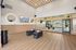 Modern fitness studio with large mirrors, stylish wood flooring, and ample natural light.