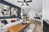 Modern living space featuring stylish abstract wall art, cozy seating area with textured cushions, and a sleek breakfast bar with chic barstools under elegant pendant lighting.