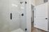 Inviting bathroom with modern glass shower and stylish fixtures, offering a bright and elegant space.