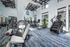 Modern fitness center with state-of-the-art gym equipment, treadmills, and motivational decor in a bright, airy space.