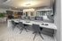 Modern co-working space with sleek computer stations, elegant lighting, and stylish decor at The Addison Longwood.