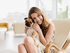 Cozy living area with natural light, featuring a cheerful woman and her adorable pug, creating a welcoming, pet-friendly atmosphere.