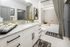Elegant bathroom with granite countertops, modern fixtures, and stylish leopard print shower curtain.