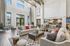 Luxurious open-concept living area with high ceilings, elegant decor, and abundant natural light, perfect for relaxation and entertaining.