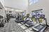 Bright, modern fitness center featuring state-of-the-art exercise equipment, large windows, and a welcoming atmosphere.