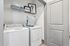 Modern laundry room featuring efficient appliances and ample storage with stylish decor.