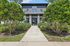 Inviting entrance to a modern apartment complex, surrounded by lush greenery and elegant architecture.