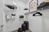 Elegant and spacious walk-in closet with sleek shelves, designer bags, and stylish hangers, perfect for organizing your wardrobe.