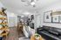 Contemporary open-concept living space with modern kitchen, dining area, and cozy seating, featuring sleek decor and stylish lighting.