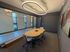 Sleek and modern conference room with stylish lighting, glass walls, and contemporary artwork.