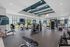 Spacious and modern fitness center equipped with state-of-the-art machines, free weights, and a dedicated training zone with punching bags.