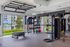 Modern fitness center with advanced training equipment and vibrant outdoor pool view, perfect for active living.
