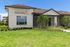 Inviting dog spa exterior with modern architecture and lush green landscaping, perfect for pet pampering and relaxation.