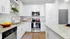 Modern kitchen with sleek white cabinets, granite countertops, and stainless steel appliances, providing a chic and inviting culinary space.