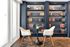 Chic reading nook with elegant navy bookshelves, designer chairs, and a cozy round table for a serene escape.