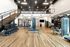 Modern fitness center featuring state-of-the-art equipment, sleek design, and spacious layout with mezzanine level.