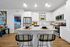 Modern kitchen with sleek white cabinets, stainless steel appliances, and an inviting island with chic bar stools.