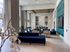 furnished clubroom with high ceilings