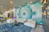 furnished clubroom with accent wall and sofa