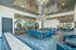 furnished clubroom with seating and table