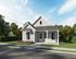 Opelika, AL Townhomes - Champions Square - Exterior of a Home with an Exposed Porch, Manicured Grass Lawn, Flowering Plants, Trees, Hedgerows, and Concrete Sidewalk.