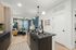 Furnished kitchen overlooking living room
