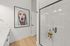 Furnished bathroom with walk-in shower and double vanity