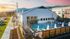 Exterior of clubhouse with pool at sunset