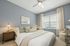 Primary bedroom with bed and dresser