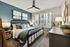 Primary bedroom with bed and sidetables