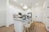 Furnished kitchen with large island and chairs