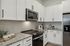 furnished kitchen with stovetop and microwave
