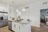furnished kitchen area with island and refridgerator