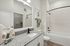 furnished bathroom with sink, toilet and shower