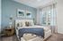 furnished bedroom with bed and window in apartment
