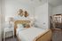 furnished bedroom with bed and side table