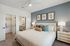 furnished bedroom with bed and side table