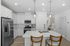 Furnished kitchen with large island and white cabinets