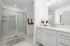 Large bathroom with double vanity and walk-in shower