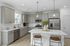 Furnished kitchen with large island and grey cabinets