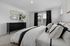 Furnished guest bedroom with large bed and side tables