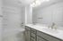 Large bathroom with double vanity and shower tub combo