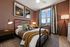 Furnished bedroom with bed and sidetables