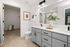Furnished bathroom with grey cabinets and large double vanity